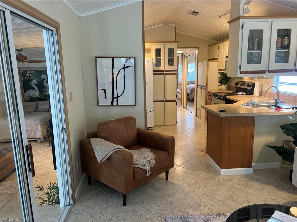 159 Cheetah Drive, Unit 159 Naples, FL 34114 - Photo 18 of 31 a living room with furniture and a window
