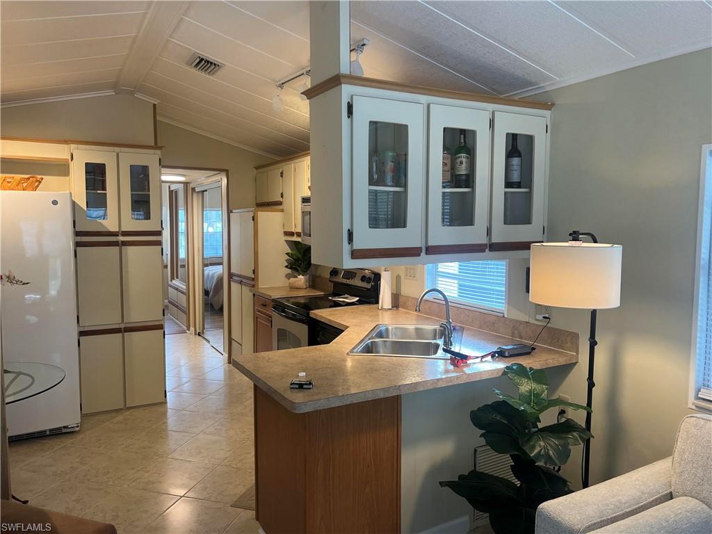 159 Cheetah Drive, Unit 159 Naples, FL 34114 - Photo 19 of 31 a kitchen with sink refrigerator and microwave