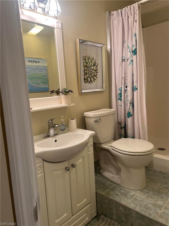 159 Cheetah Drive, Unit 159 Naples, FL 34114 - Photo 29 of 31 a bathroom with a toilet sink and mirror