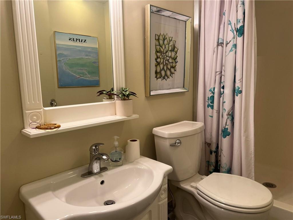 159 Cheetah Drive, Unit 159 Naples, FL 34114 - Photo 30 of 31 a bathroom with a sink a mirror and a toilet