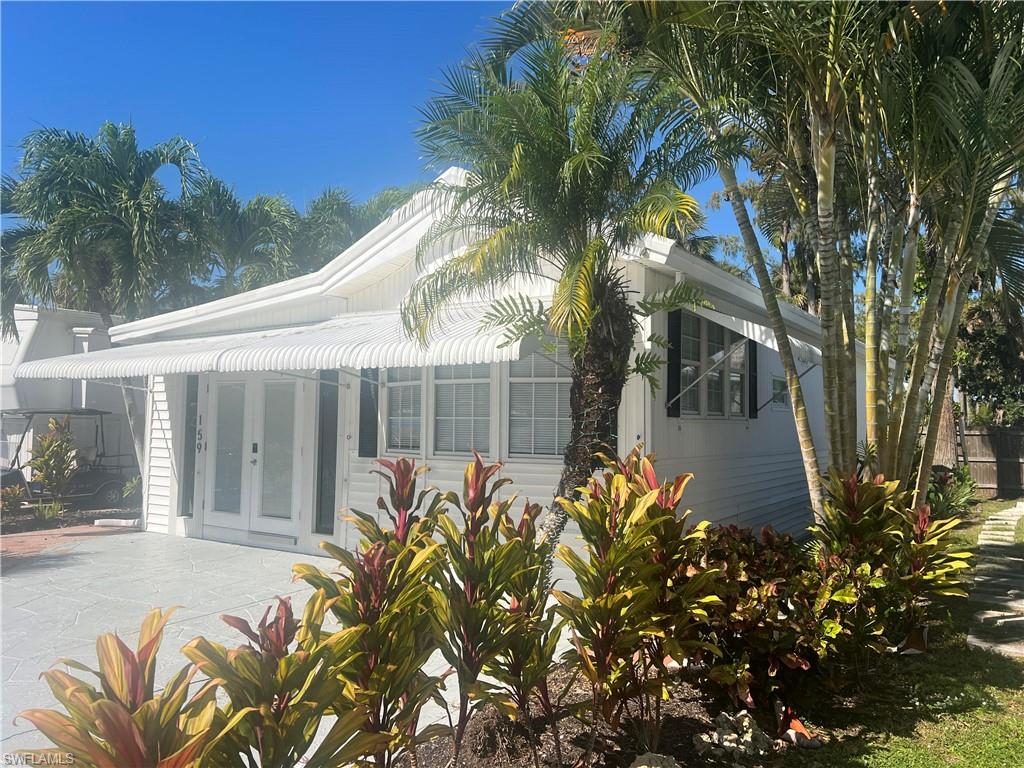159 Cheetah Drive, Unit 159 Naples, FL 34114 - Photo 4 of 31 a front view of a house with a yard