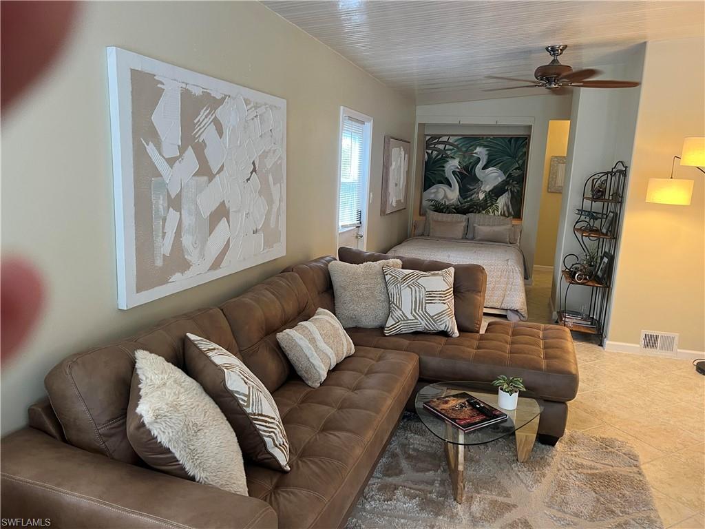 159 Cheetah Drive, Unit 159 Naples, FL 34114 - Photo 6 of 31 a living room with furniture and a painting