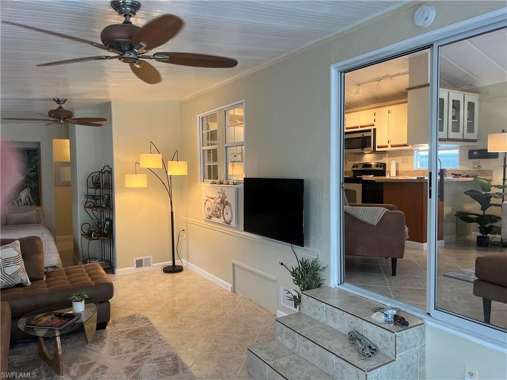 159 Cheetah Drive, Unit 159 Naples, FL 34114 - Photo 7 of 31 a living room with furniture and a flat screen tv