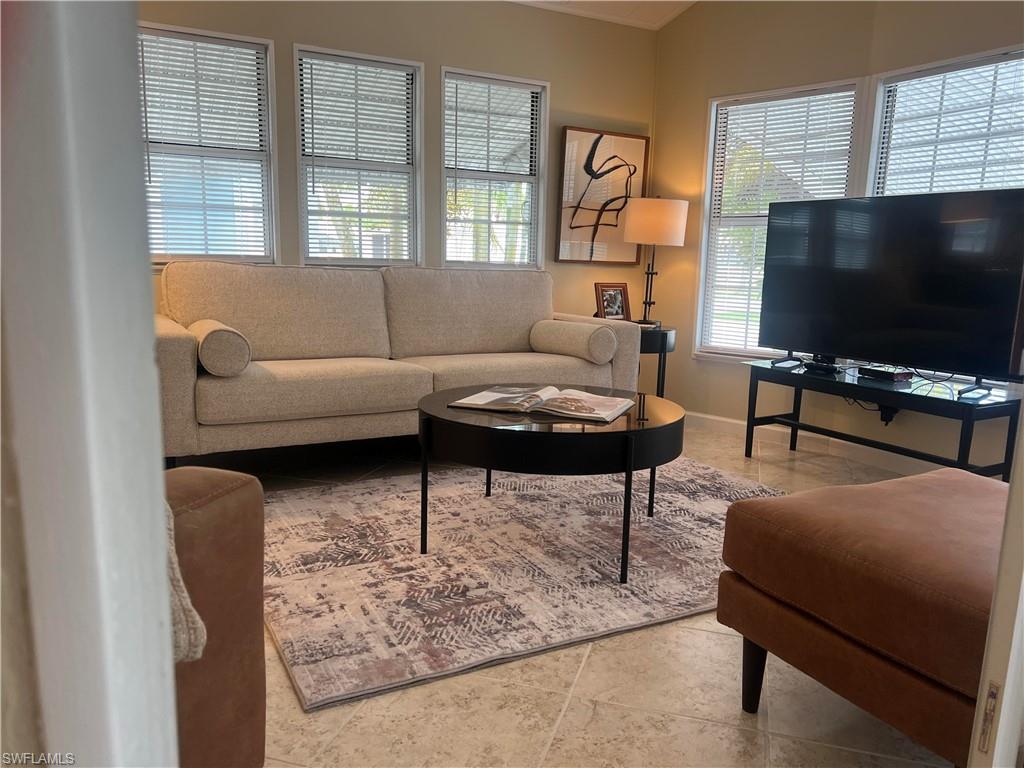 159 Cheetah Drive, Unit 159 Naples, FL 34114 - Photo 10 of 31 a living room with furniture and a flat screen tv