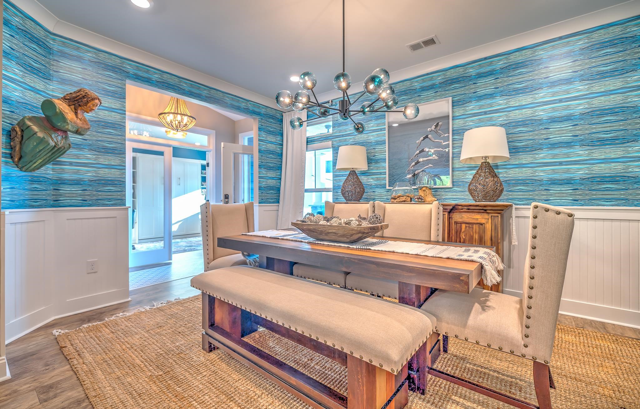 2488 Goldfinch Drive Myrtle Beach, SC 29577 - Photo 12 of 38 Dining area with wallpapered walls, wainscoting, a chandelier, wood finished floors, and a decorative wall