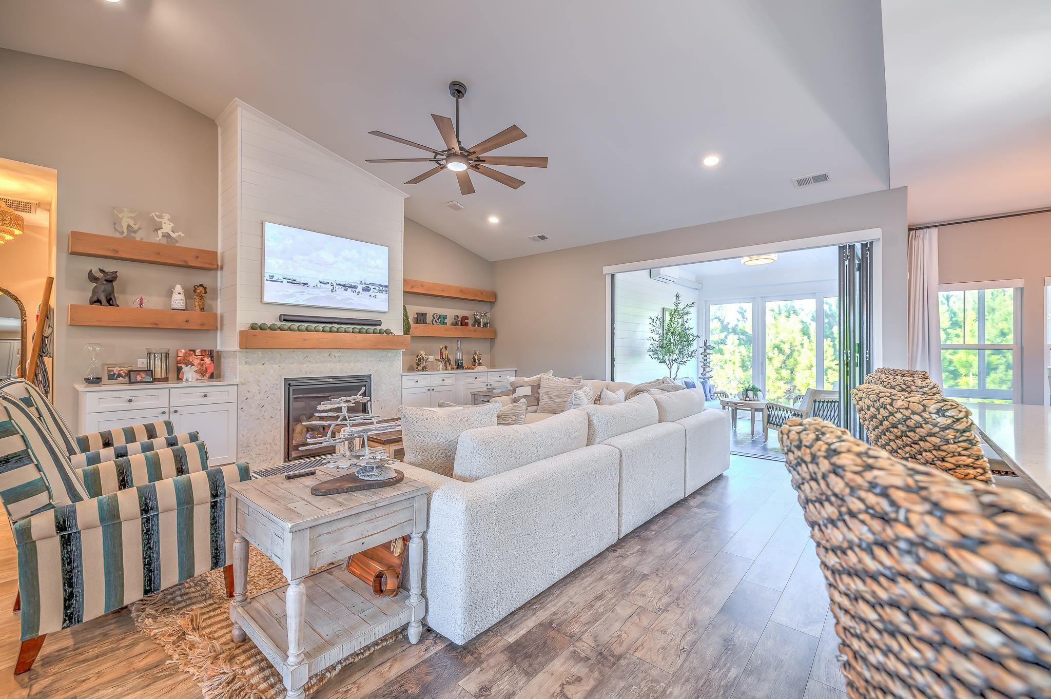 2488 Goldfinch Drive Myrtle Beach, SC 29577 - Photo 20 of 38 Living room with vaulted ceiling, hardwood / wood-style flooring, recessed lighting, ceiling fan, and a glass covered fireplace