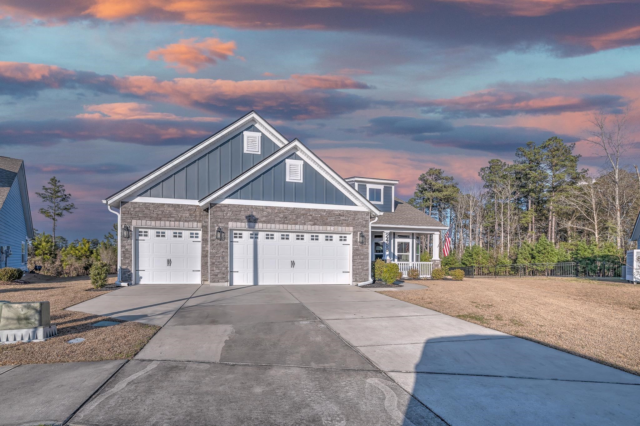 2488 Goldfinch Drive Myrtle Beach, SC 29577 - Photo 3 of 38 Craftsman-style house with driveway, board and batten siding, an attached garage, and covered porch