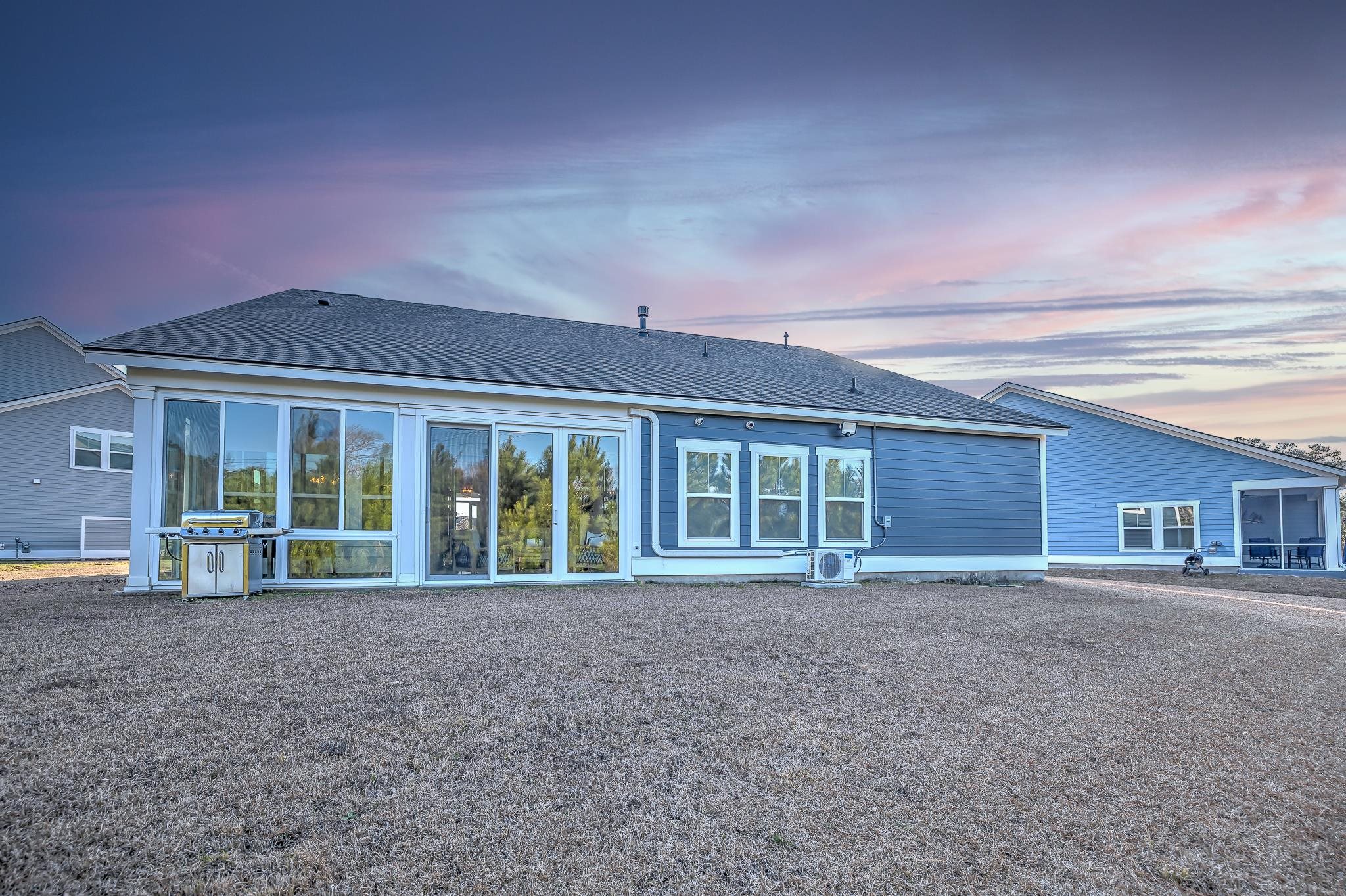2488 Goldfinch Drive Myrtle Beach, SC 29577 - Photo 30 of 38 Rear view of property with a shingled roof and a sunroom