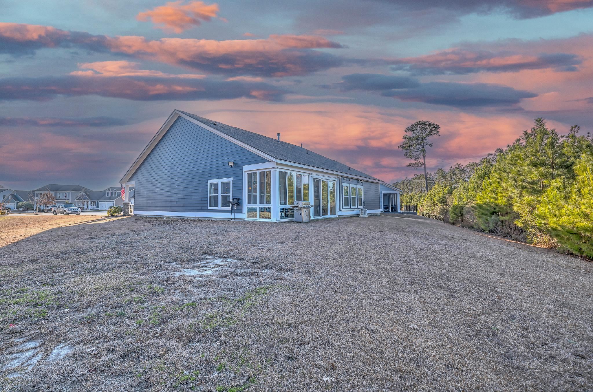 2488 Goldfinch Drive Myrtle Beach, SC 29577 - Photo 31 of 38 View of side of home with a sunroom, a shingled roof, and a patio