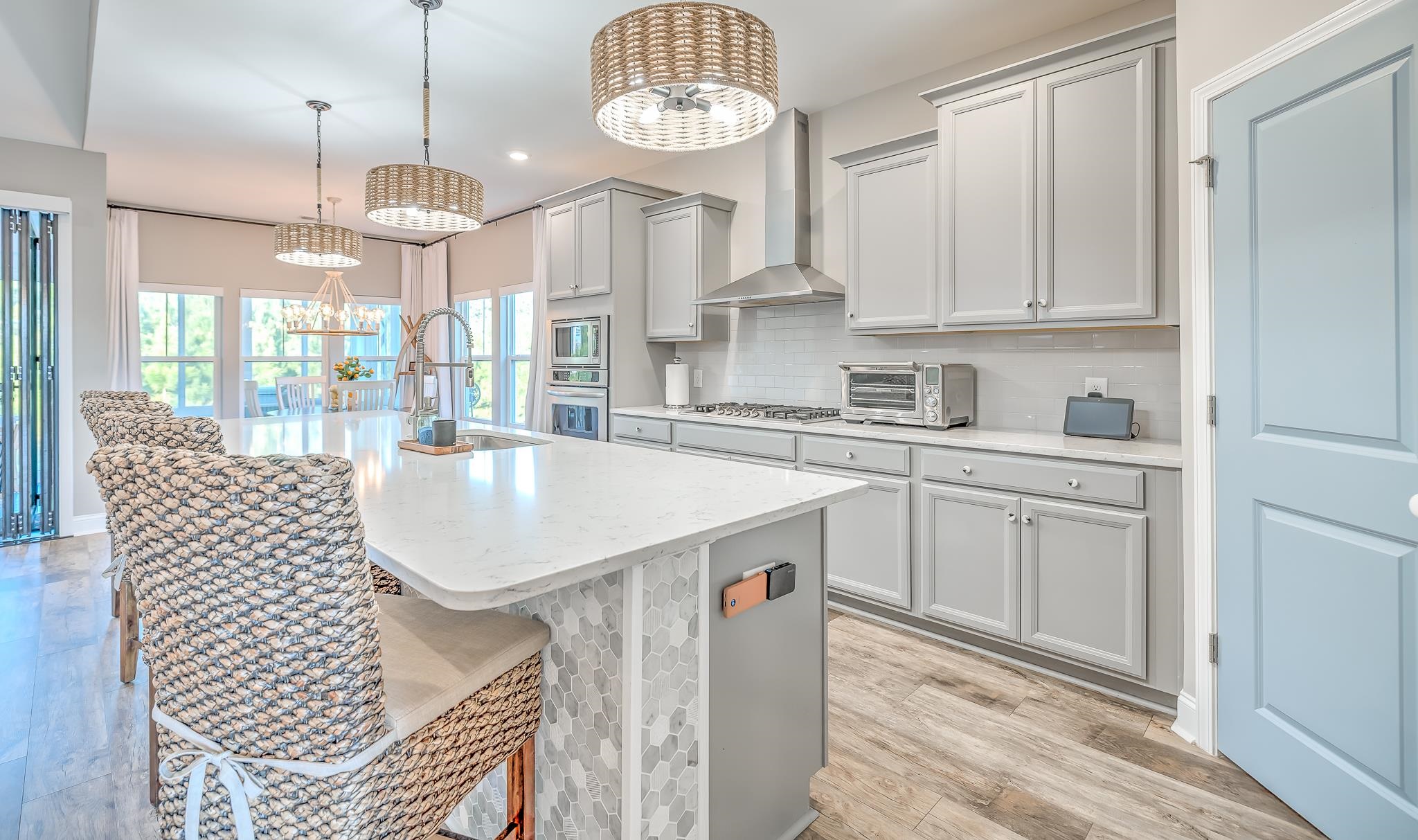 2488 Goldfinch Drive Myrtle Beach, SC 29577 - Photo 4 of 38 Kitchen with a chandelier, light wood finished floors, gray cabinetry, wall chimney exhaust hood, and recessed lighting
