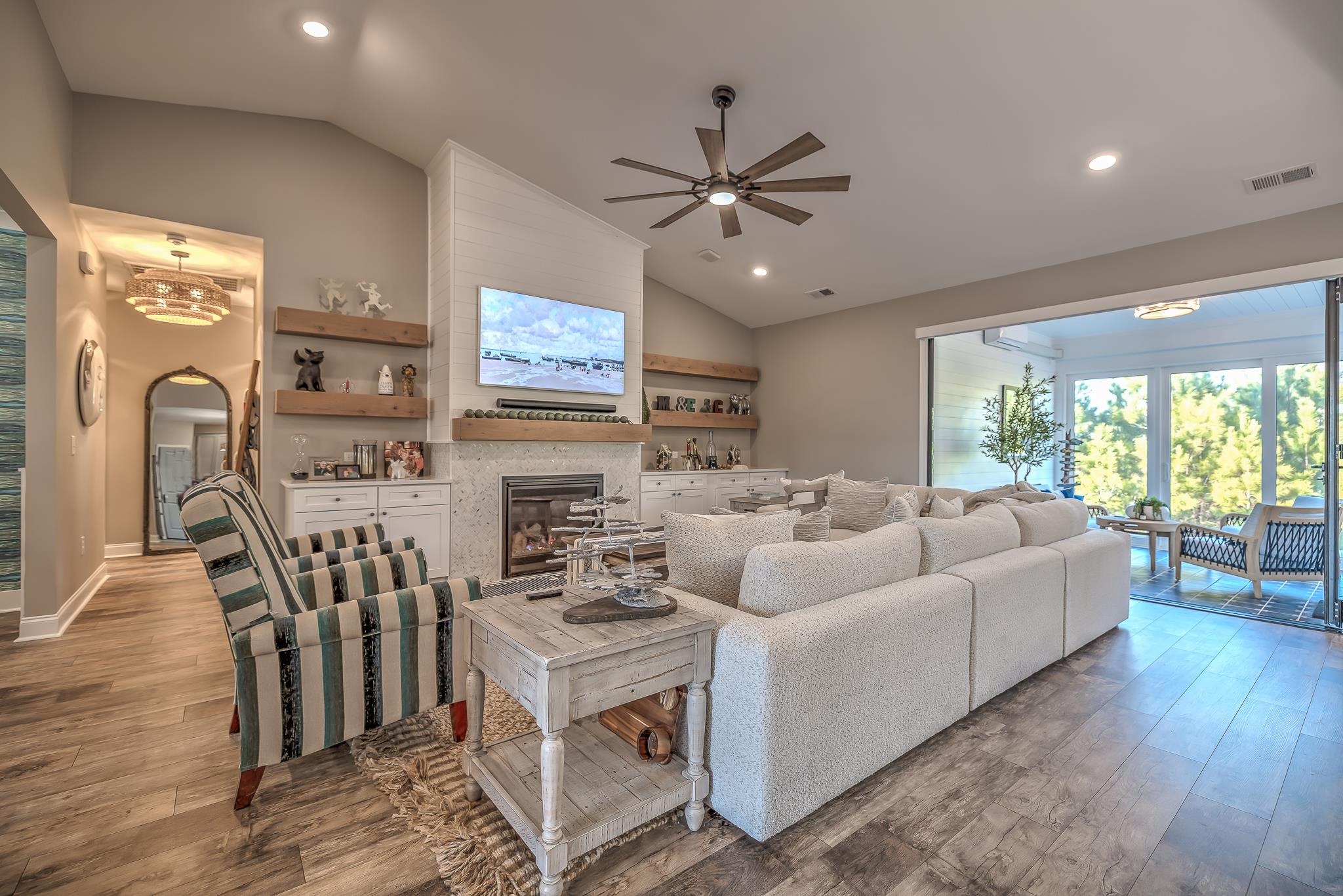 2488 Goldfinch Drive Myrtle Beach, SC 29577 - Photo 9 of 38 Living area featuring vaulted ceiling, wood finished floors, recessed lighting, a glass covered fireplace, and ceiling fan
