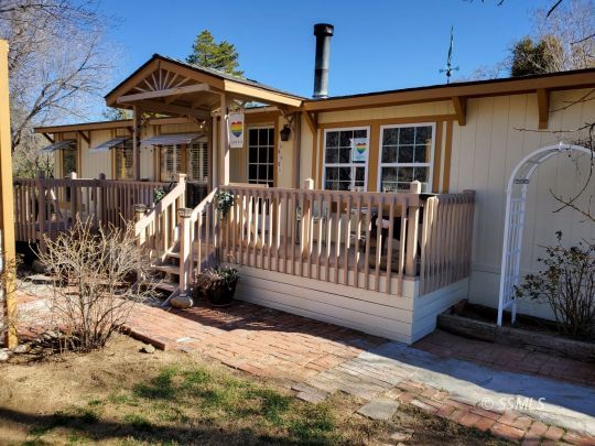 8926 Caliente Bodfish Road Caliente, CA 93518 - Photo 1 of 43 a view of a house with a small yard and wooden fence