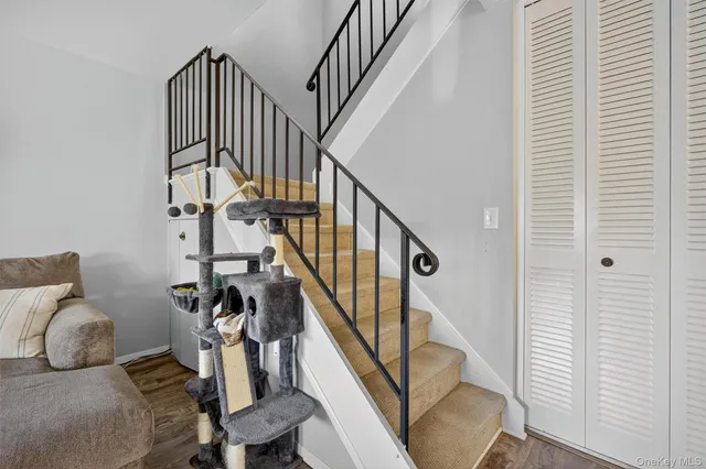 a view of entryway with wooden floor and stairs