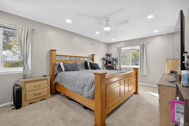 a large bed sitting in a room next to a window