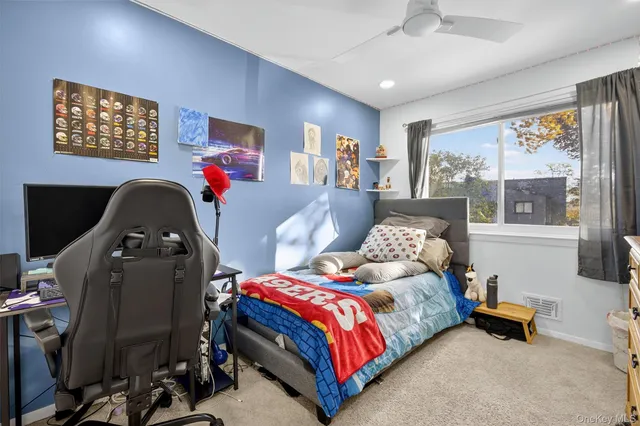 a bedroom with bed and a large window