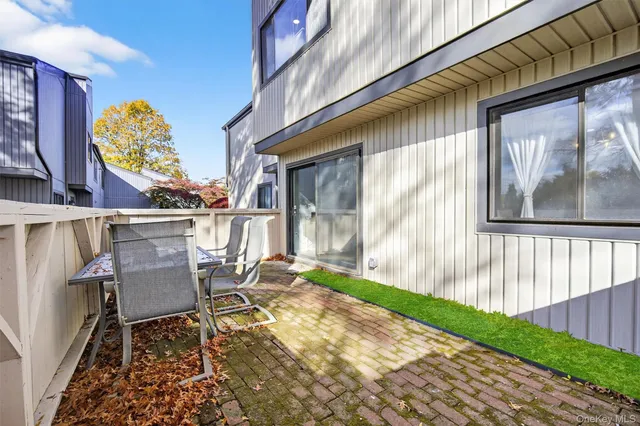 a backyard of a house with table and chairs
