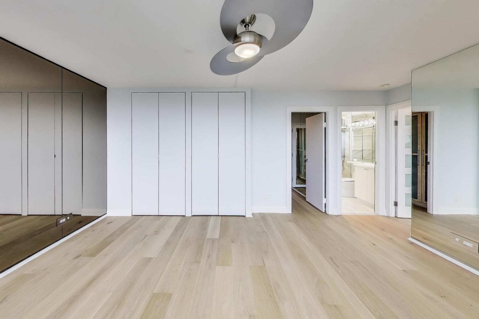5201 South Cornell Avenue, Unit 20E Chicago, IL 60615 - Photo 12 of 20 a view of an empty room with wooden floor