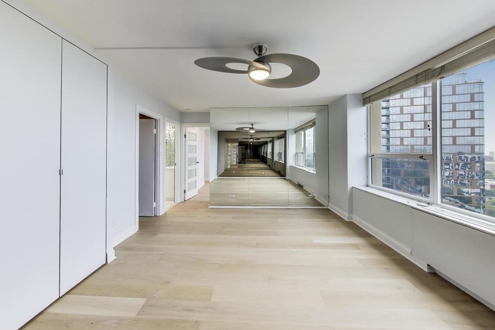 5201 South Cornell Avenue, Unit 20E Chicago, IL 60615 - Photo 13 of 20 a view of a hallway with wooden floor and a chandelier