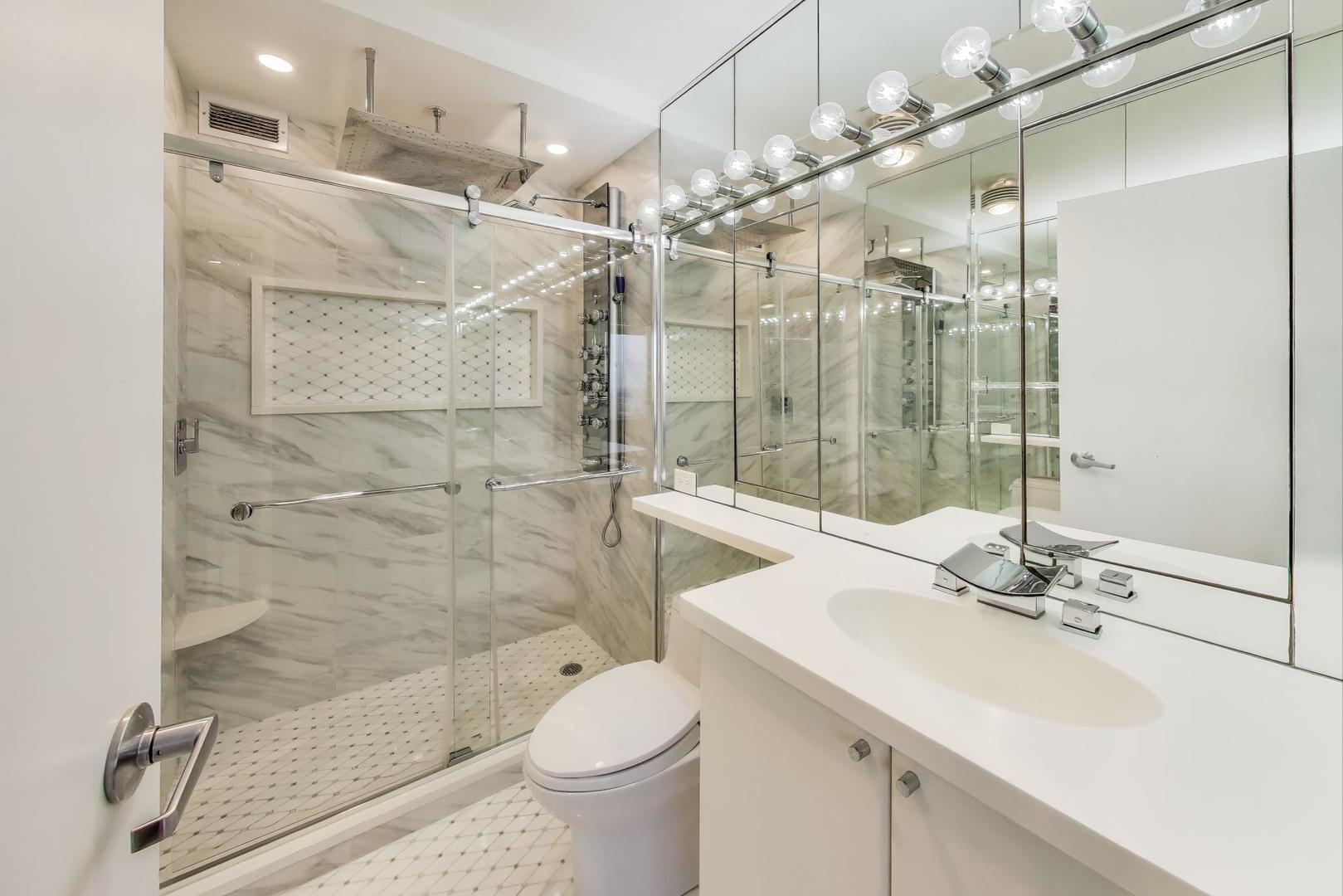 5201 South Cornell Avenue, Unit 20E Chicago, IL 60615 - Photo 14 of 20 a bathroom with a sink shower and a mirror