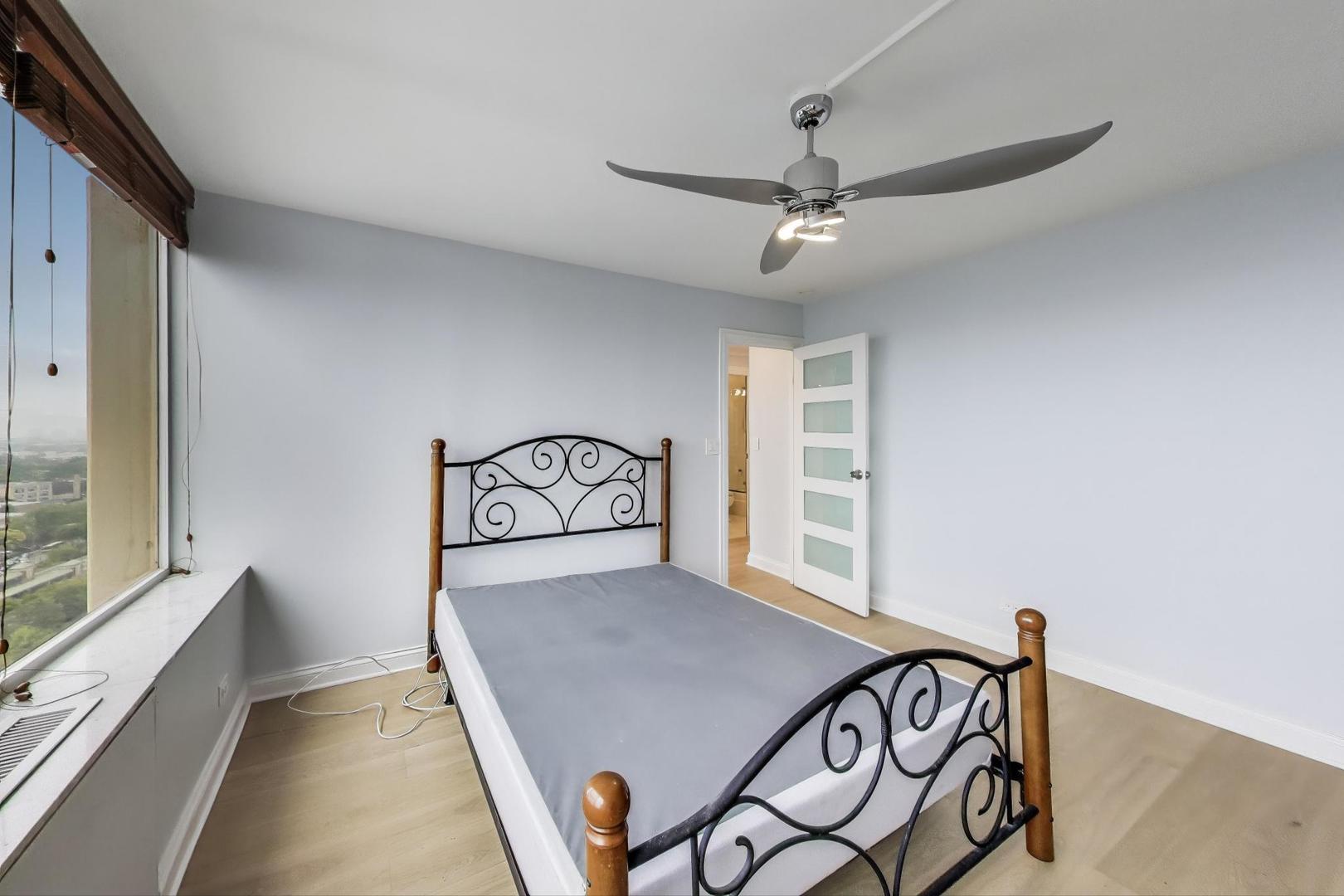 5201 South Cornell Avenue, Unit 20E Chicago, IL 60615 - Photo 15 of 20 a view of a room with window and furniture