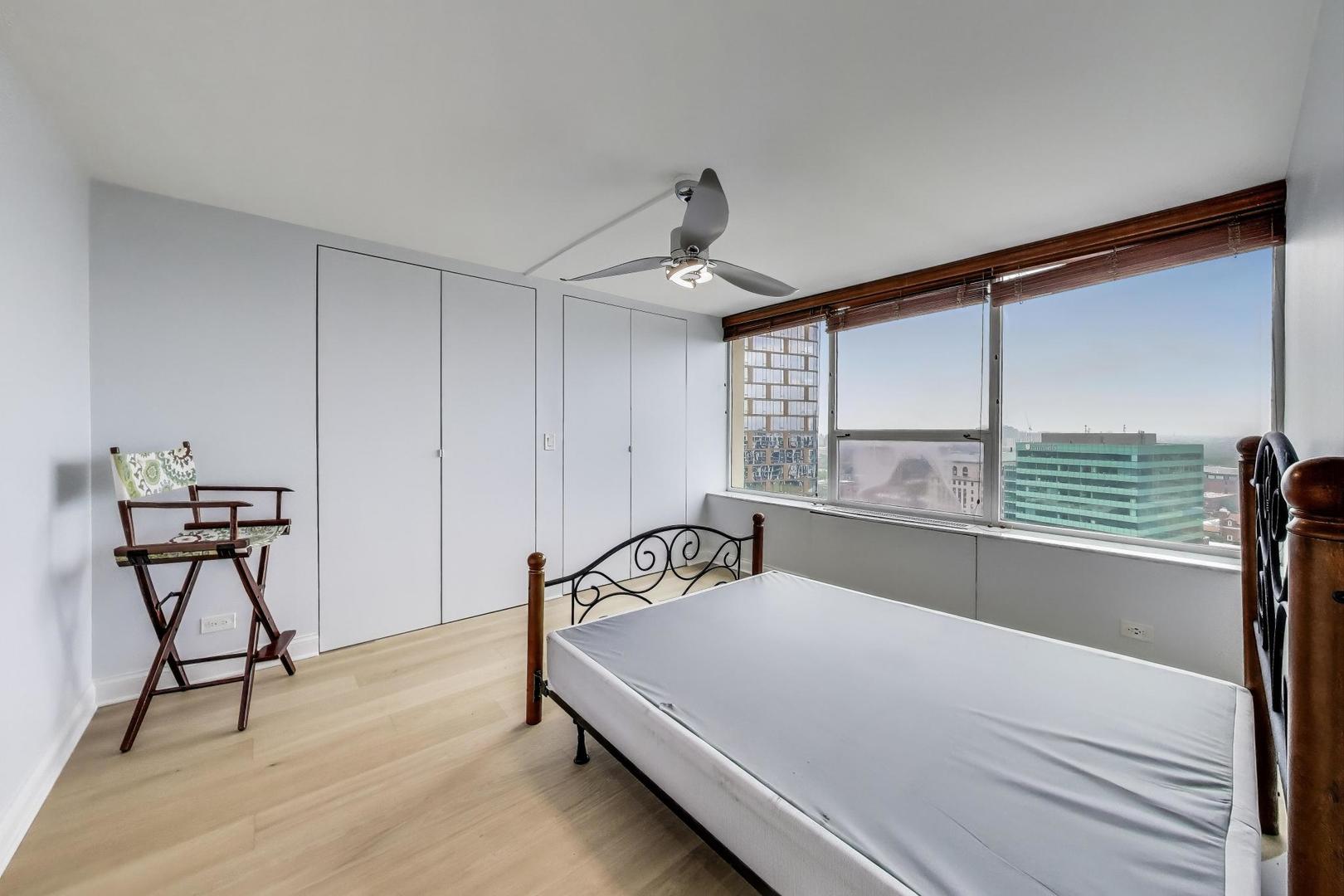 5201 South Cornell Avenue, Unit 20E Chicago, IL 60615 - Photo 16 of 20 a bedroom with a bed and window