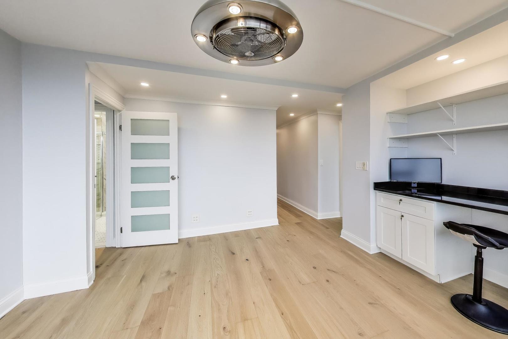 5201 South Cornell Avenue, Unit 20E Chicago, IL 60615 - Photo 9 of 20 a view of an empty room and a kitchen