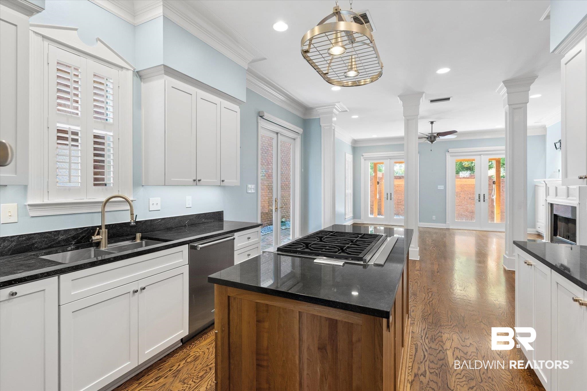 107 Fielding Place Mobile, AL 36608 - Photo 7 of 27 Kitchen with decorative columns, a sink, stainless steel appliances, french doors, and crown molding
