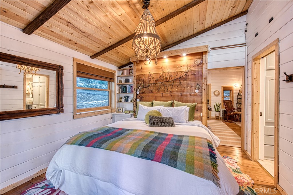 9287 Corral Road Forest Falls, CA 92339 - Photo 19 of 26 a bedroom with a large bed and a large window