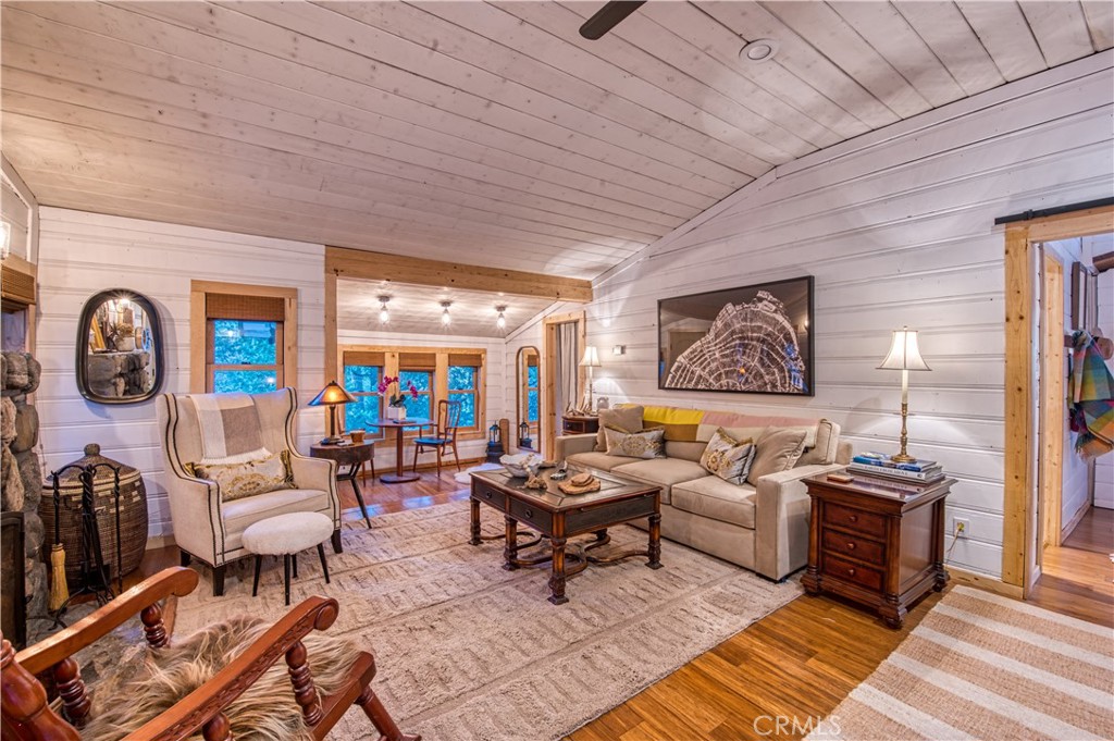 9287 Corral Road Forest Falls, CA 92339 - Photo 5 of 26 a living room with furniture a rug and a floor to ceiling window