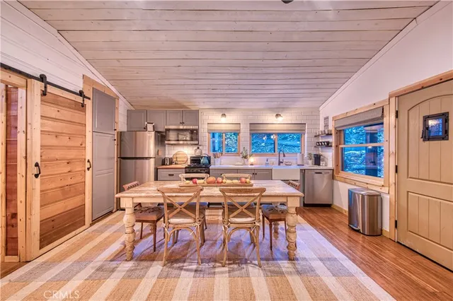 a view of a dining room with furniture wooden floor and a rug