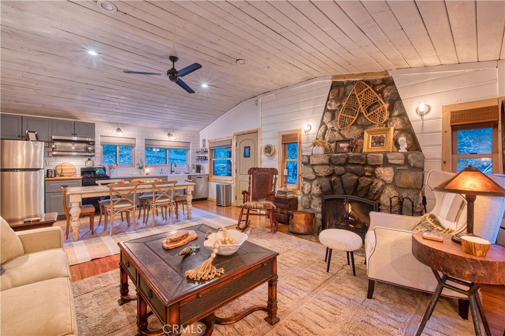 9287 Corral Road Forest Falls, CA 92339 - Photo 9 of 26 a living room with lots of furniture and a dining table with wooden floor