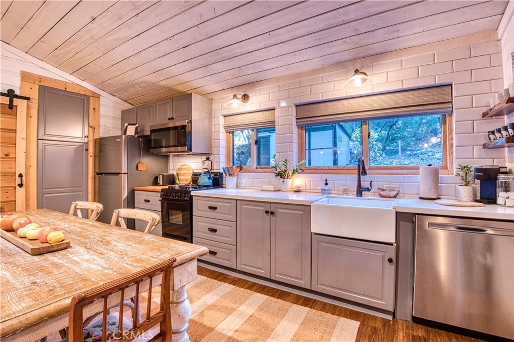 9287 Corral Road Forest Falls, CA 92339 - Photo 10 of 26 a kitchen with stainless steel appliances granite countertop a sink a stove and refrigerator