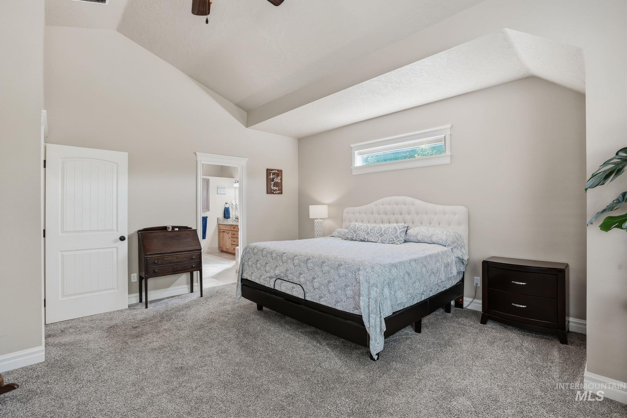 3969 North Hollymount Way Meridian, ID 83646 - Photo 23 of 47 Spacious room featuring vaulted ceilings, a large window, light gray walls, and plush gray carpet flooring