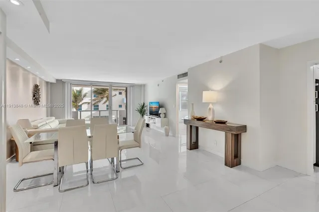 a view of a kitchen with furniture and an empty room