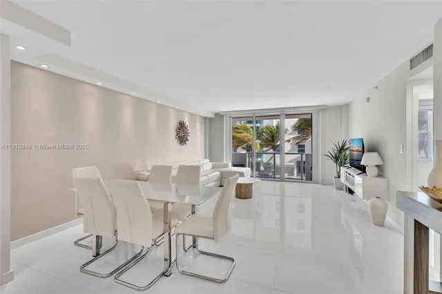 a living room with furniture and floor to ceiling window