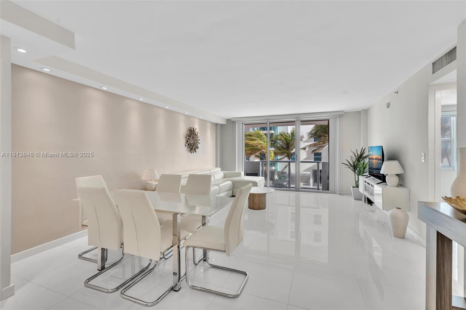 9195 Collins Avenue, Unit 303 Surfside, FL 33154 - Photo 16 of 44 a view of a livingroom with furniture and a potted plant