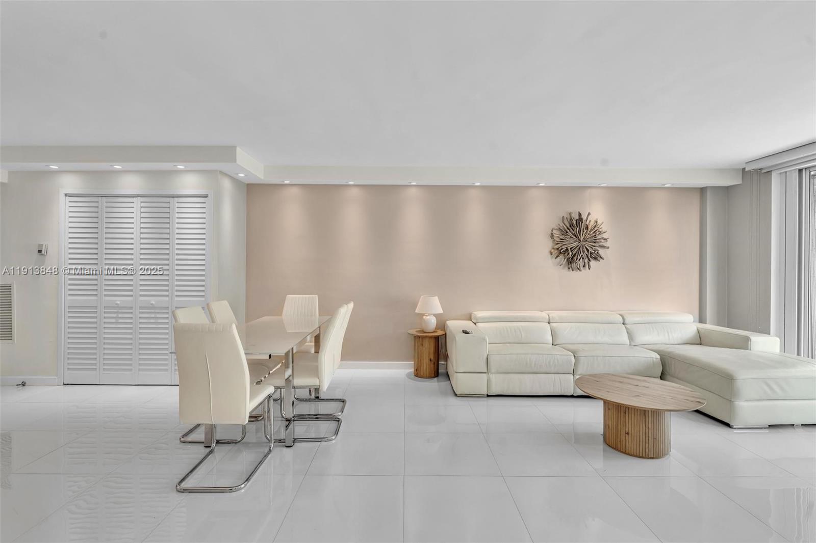 9195 Collins Avenue, Unit 303 Surfside, FL 33154 - Photo 17 of 44 a living room with furniture and floor to ceiling window