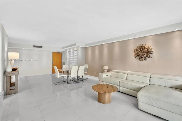 a living room with furniture a flat screen tv and a large window