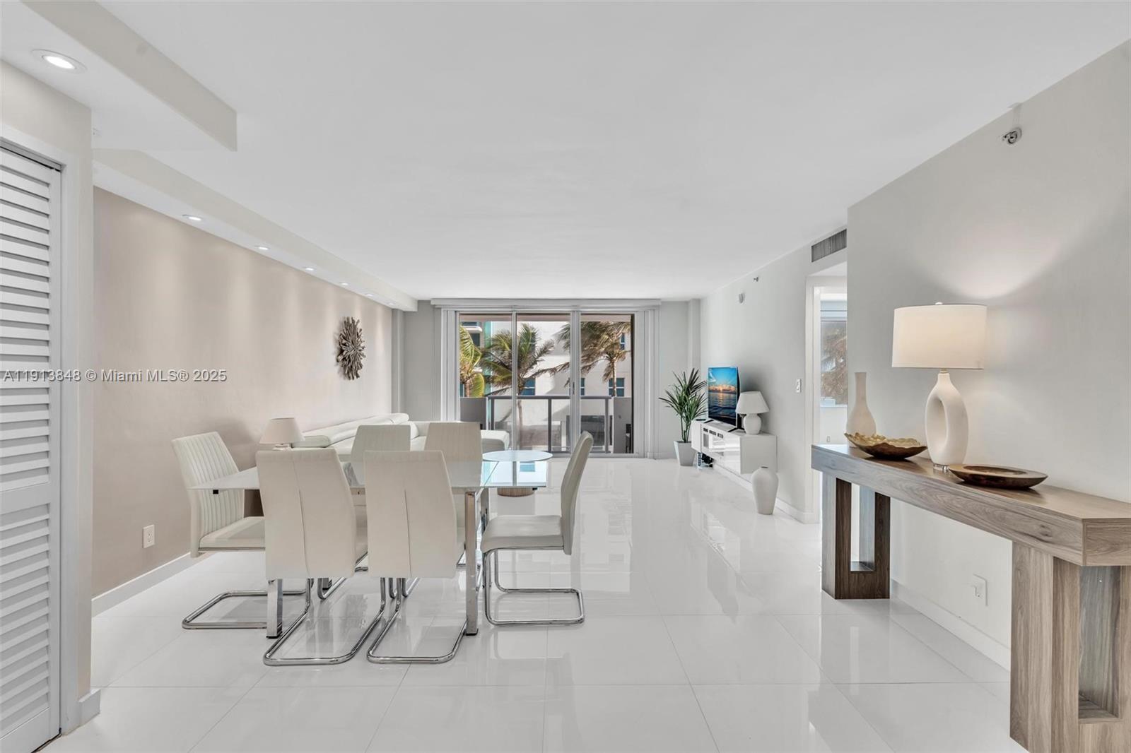 9195 Collins Avenue, Unit 303 Surfside, FL 33154 - Photo 2 of 44 a view of a dining room with furniture
