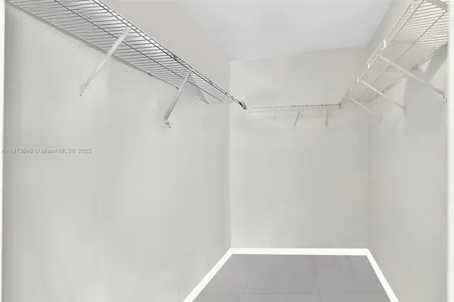 a view of a livingroom with furniture and floor to ceiling window