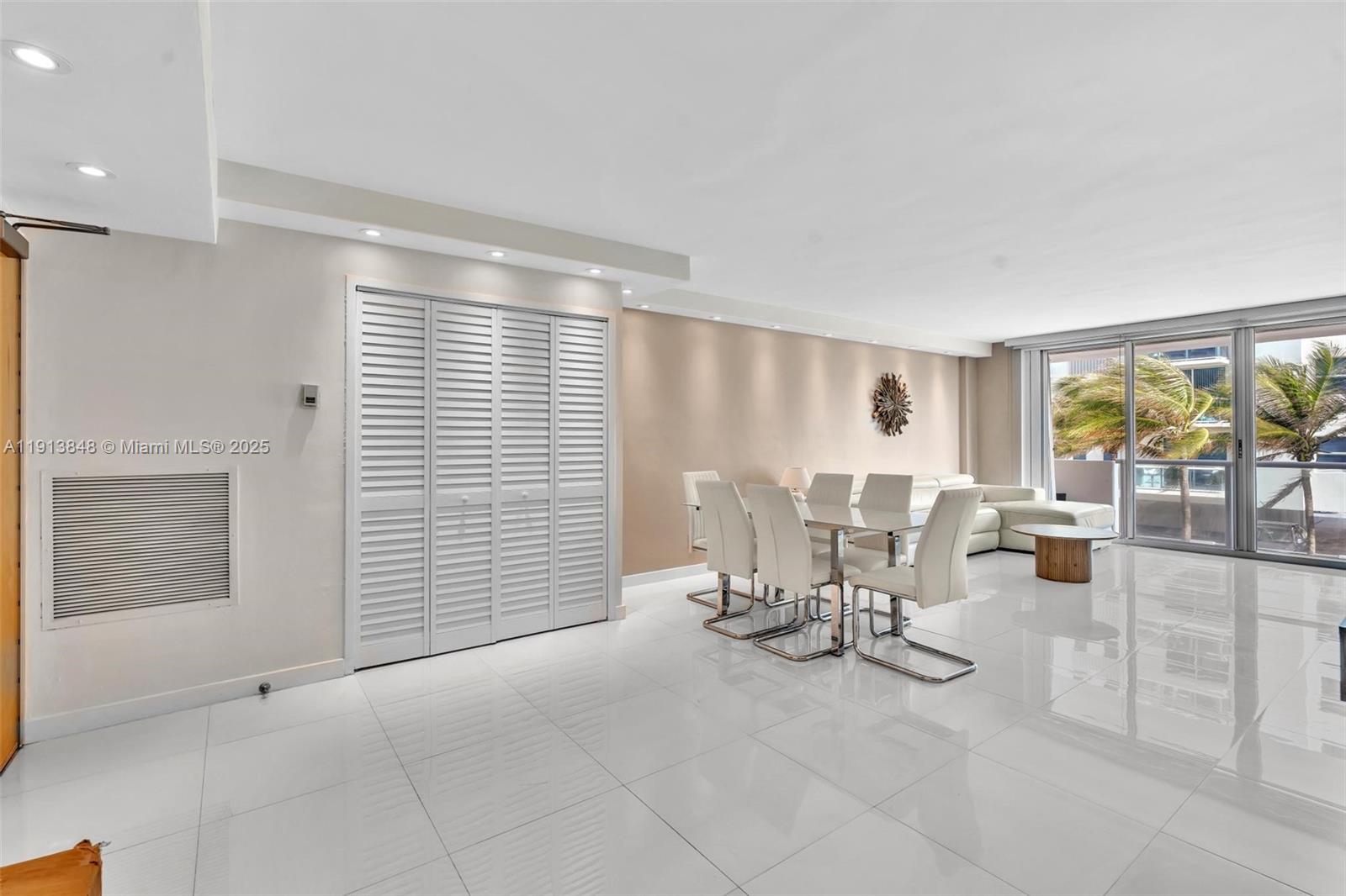 9195 Collins Avenue, Unit 303 Surfside, FL 33154 - Photo 36 of 44 a view of a livingroom with furniture and floor to ceiling window