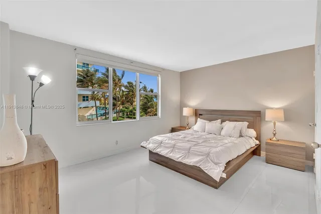 a bedroom with a bed lamp and a window