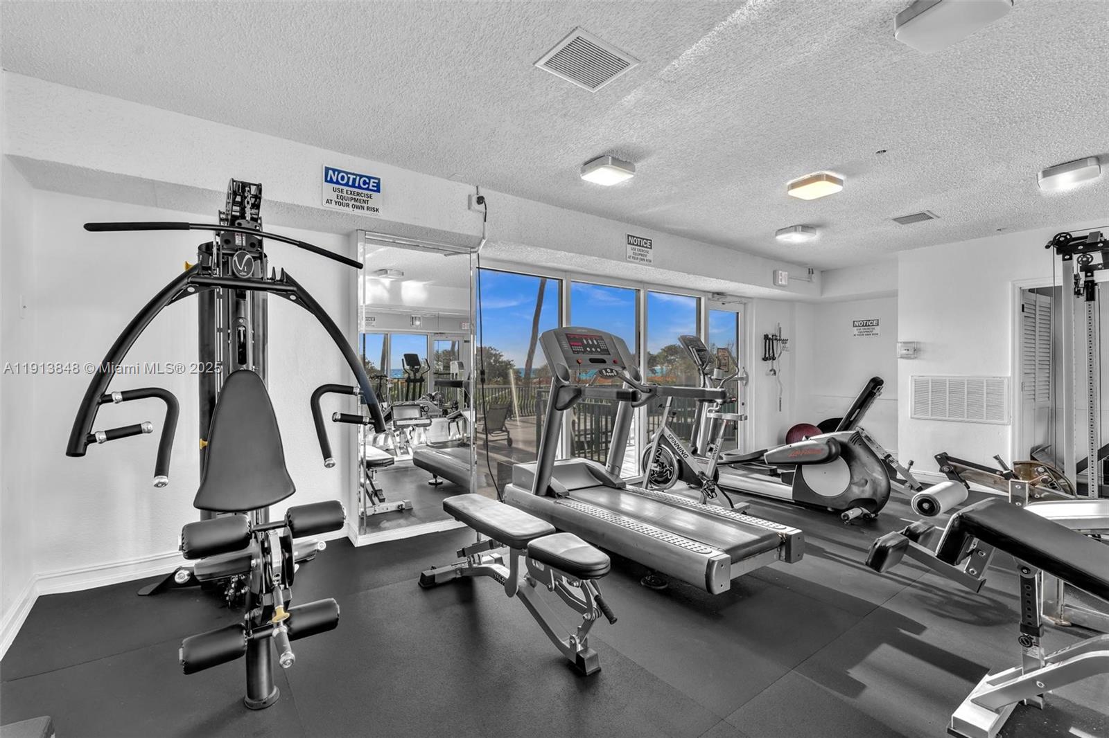 9195 Collins Avenue, Unit 303 Surfside, FL 33154 - Photo 8 of 44 a view of a room with gym equipment