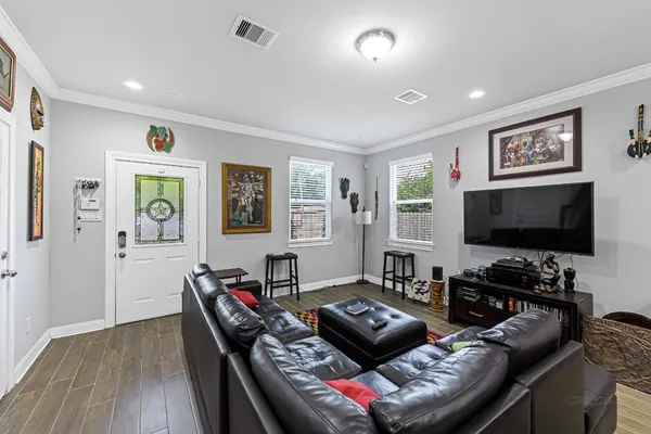 a living room with furniture and a flat screen tv
