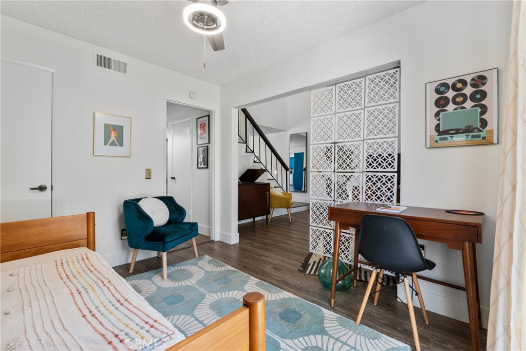 6134 Arroyo Road, Unit 3 Palm Springs, CA 92264 - Photo 13 of 35 a living room with furniture and a dining table with wooden floor
