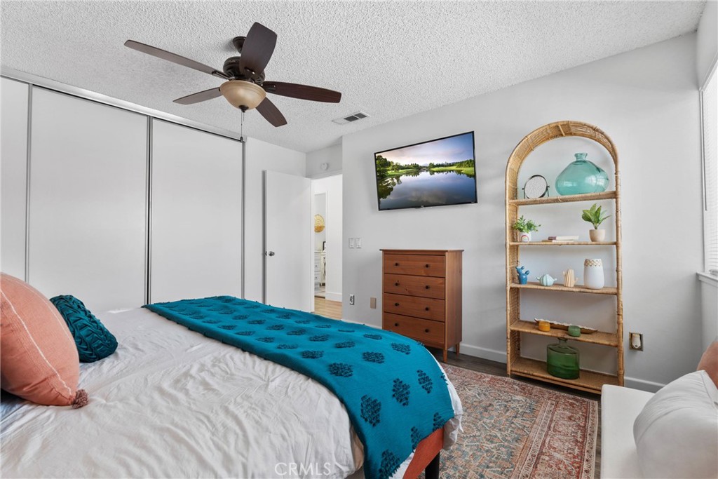 6134 Arroyo Road, Unit 3 Palm Springs, CA 92264 - Photo 16 of 35 a bedroom with a bed a dresser and flowerpot