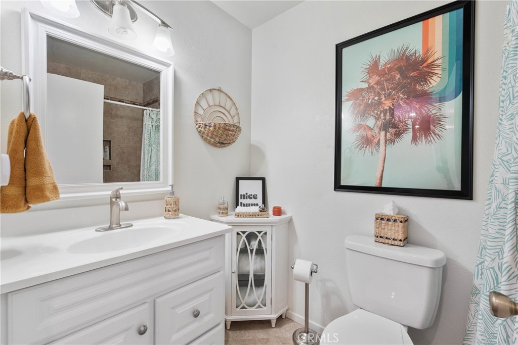 6134 Arroyo Road, Unit 3 Palm Springs, CA 92264 - Photo 18 of 35 a bathroom with a toilet a sink and mirror