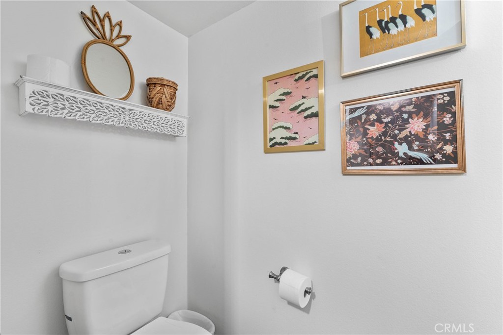 6134 Arroyo Road, Unit 3 Palm Springs, CA 92264 - Photo 21 of 35 a bathroom with a toilet and a picture on the wall
