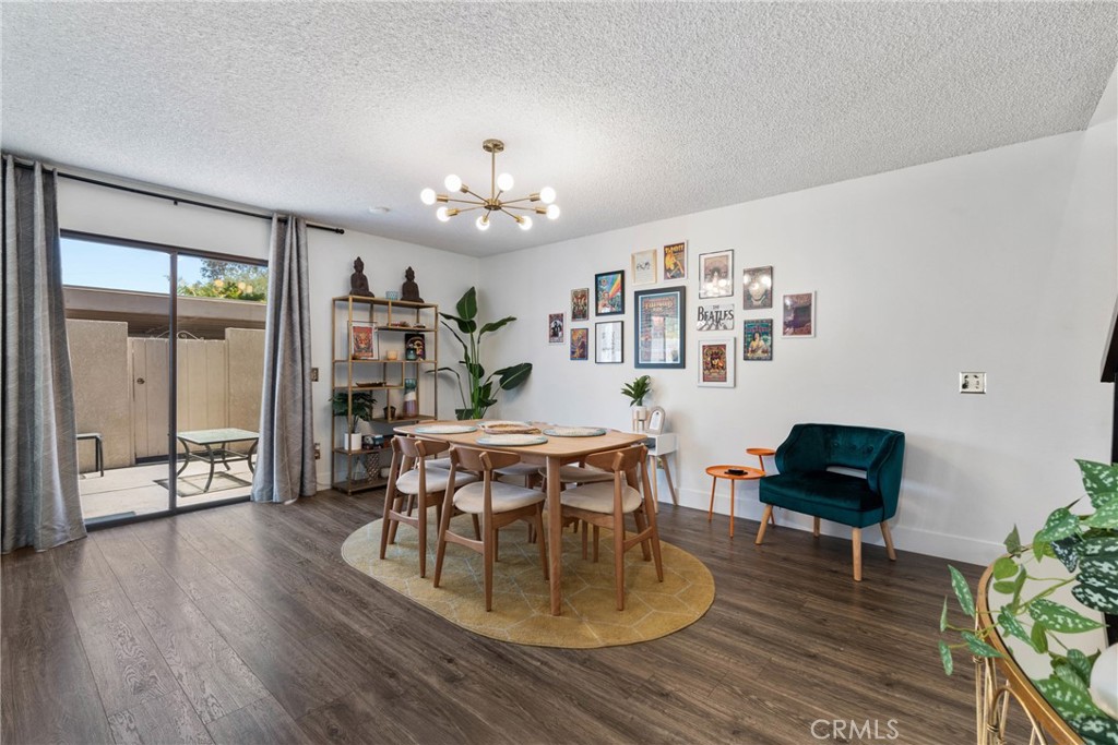 6134 Arroyo Road, Unit 3 Palm Springs, CA 92264 - Photo 6 of 35 a view of a dining room with furniture and wooden floor
