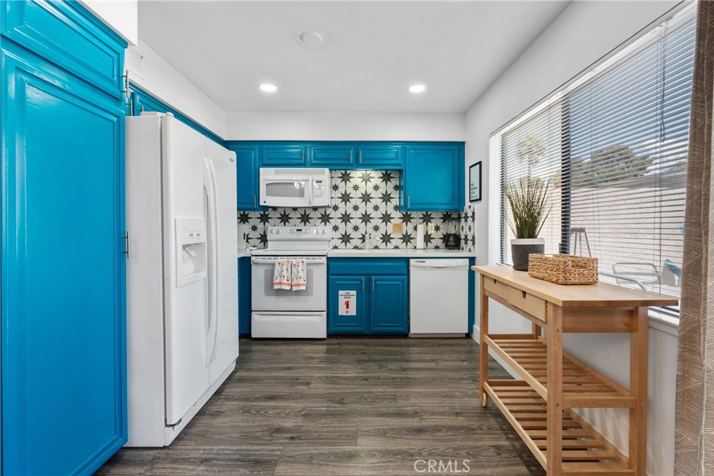 6134 Arroyo Road, Unit 3 Palm Springs, CA 92264 - Photo 8 of 35 a kitchen with stainless steel appliances granite countertop a stove and refrigerator